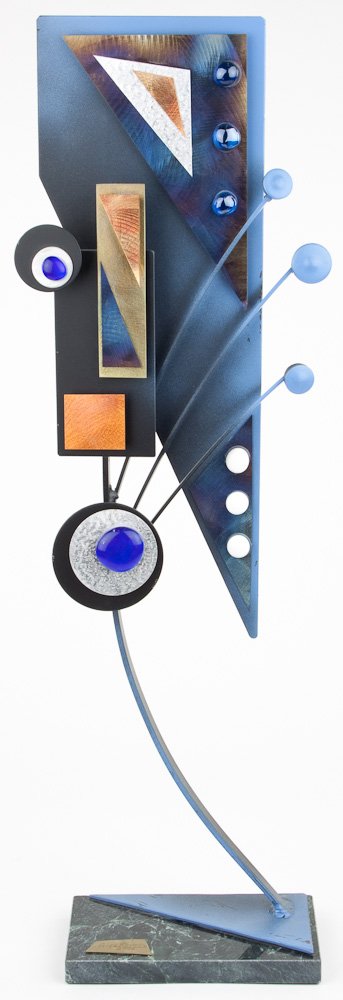 METAL SCULPTURE - ALEX KOVACS: METAL SCULPTURE - ALEX KOVACS Alex Kovacs. (b. Budapest, 1947) Mixed media metal sculpture with glass accents, mounted on a stone base painted in shades of blue and black. Aprox. 20" tall.