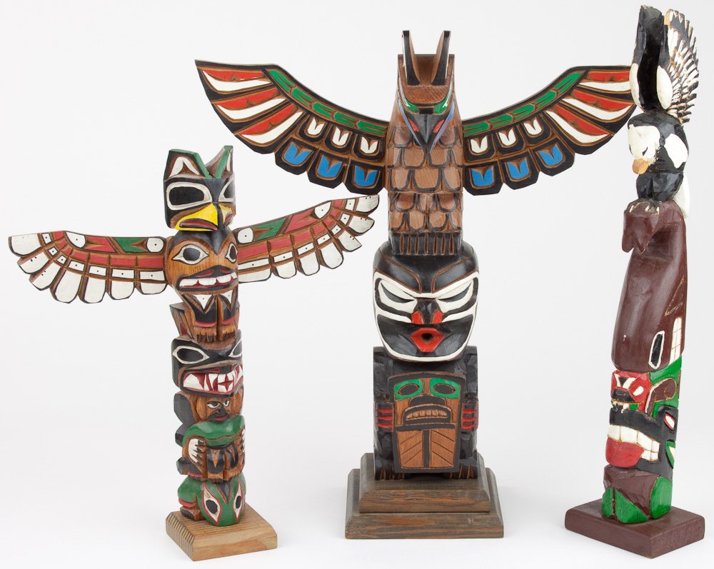 CARVED TOTEM POLES (3): CARVED TOTEM POLES (3) Three American carved totem poles, two painted, all signed. Average 16" tall.