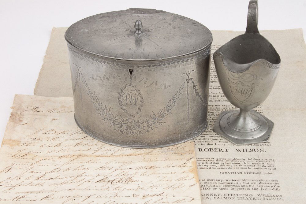 THE MAN WHO ACEPTED THE COLORS AT CORNWALLIS' SURRENDER: THE MAN WHO ACEPTED THE COLORS AT CORNWALLIS' SURRENDER - ROBERT WILSON'S TEA CADDY AND CREAM PITCHER A fine and important group of relics from Ensign ROBERT WILSON (1755-1811), the youngest commissio