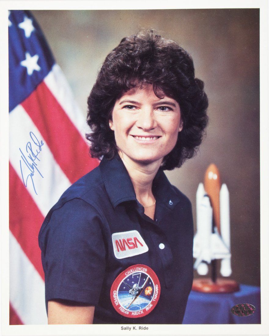 SALLY RIDE: SALLY RIDE (1951 - 2012) American astronaut, the first American woman in space. Official NASA 8" x 10" color photo, signed by Ride in blue marker at left. Fine.