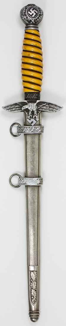 2ND MODEL LUFTWAFFE DAGGER: 2ND MODEL LUFTWAFFE DAGGER Luftwaffe dagger second model with scabbard orange grip with tight wire wrap bears only a small chip at top. Crossguard and pommel are oxidized but retain much good detail e