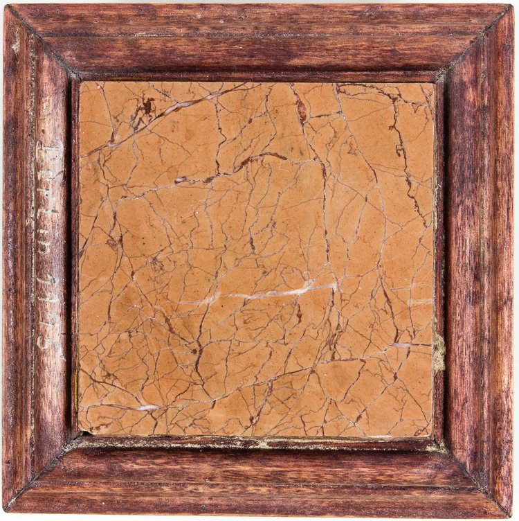 RELIC FROM ADOLF HITLER'S OFFICE: RELIC FROM ADOLF HITLER'S OFFICE Mounted piece of light rose-colored marble with black and white striations 4"" x 4"" x 1/4"" set upon a homemade wood base inscribed: ""Berlin 1945"". The bottom of th