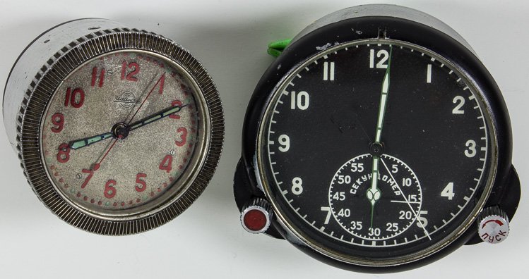 RUSSIAN MILITARY CLOCKS: RUSSIAN MILITARY CLOCKS Lot of two Russian military clocks the smaller 2 1/2"" diameter said to be from a tank and marked ""1941 24V bec 300"" on reverse the second 3 1/2"" diameter black face said to