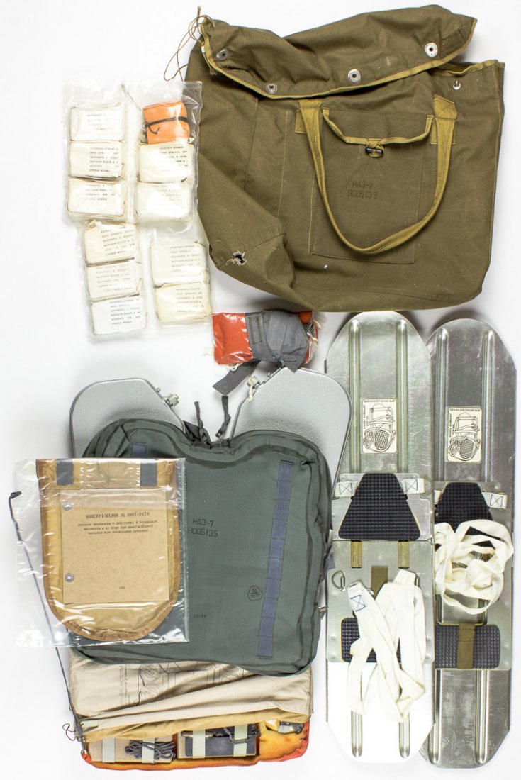 SOVIET MIG PILOT'S SURVIVAL KIT: SOVIET MIG PILOT'S SURVIVAL KIT Survival kit issued to the pilot of a ca. late 1980s pilot of a Soviet MIG fighter aircraft comprised of set of folding skis two packs of dried provisions two rubber wa