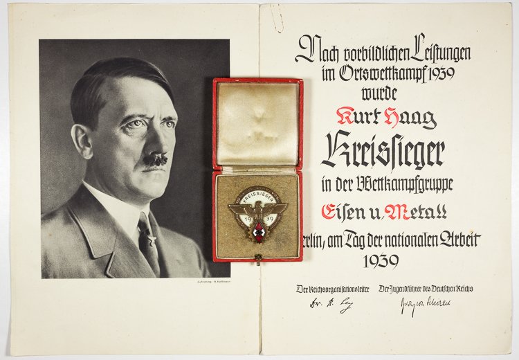 1939 KREISSIEGER AWARD AND BADGE: 1939 KREISSIEGER AWARD AND BADGE Hitler Youth Kreissieger 1939 Victors Badge in the National Trade Competition, maker Ferd. Wagner on the reverse. But for some lint and dirt, the badge is in excellent