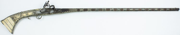 HEAVILY-DECORATED OTTOMAN EMPIRE MUSKET: HEAVILY-DECORATED OTTOMAN EMPIRE MUSKET An ornately-decorated musket dating from the Ottoman Empire. This gun bears a 41" barrel and it measures 55 1/2" long overall. The stock is elaborately ornament