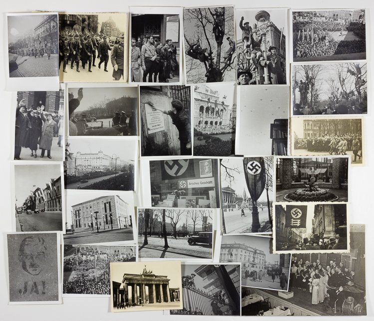 NAZI PARADE PHOTO GROUPING: NAZI PARADE PHOTO GROUPING Group of about 25 photos, most 2 1/2" x 3 1/2", largely depicting scenes of German parades in cities including marchers, buildings festooned with swastikas, people saluting 