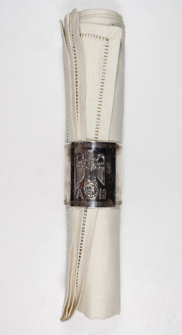 ADOLF HITLER NAPKIN RING: ADOLF HITLER NAPKIN RING Fine original formal silver napkin ring from one of Hitler's formal dinner services, 1 3/4" tall, 1 1/2" diameter, bearing a large Nazi eagle and swastika device in relief, th