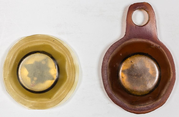 (ZEMKE'S WOLF PACK) EMERGENCY/ESCAPE COMPASSES: (ZEMKE'S WOLF PACK) EMERGENCY/ESCAPE COMPASSES Lot of two brass emergency/escape compasses, each about the size of a dime. Both are packaged in waterproof rubber containers. From the extensive collect