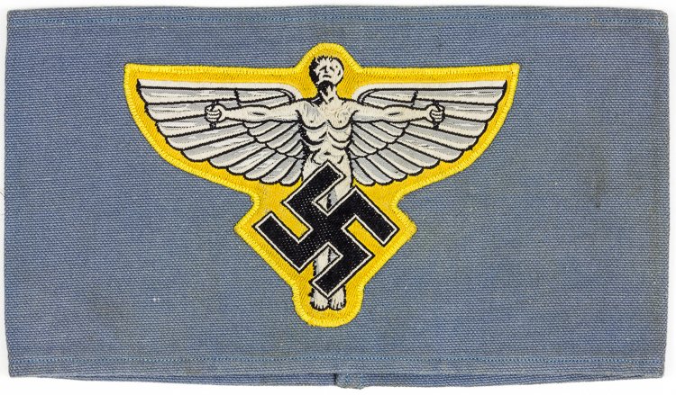 N.S.F.K. ARMBAND: N.S.F.K. ARMBAND National Socialist Flyers Corps armband, 4 1/4" wide and sewn at rear, with a 5" wide patch picturing Daedalus with a mobile swastika beneath. Zig-zag stitched on reverse. Very good.