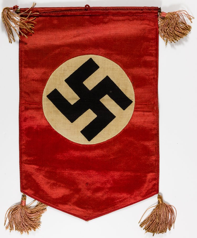 N.S.D.A.P. TABLE FLAG: N.S.D.A.P. TABLE FLAG N.S.D.A.P. table banner, 7 1/2" x 11 1/2" red rayon with white center and black printed swastika sewn to the front, tassels affixed to all four corners with a bar at top and red 