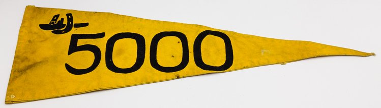 U-BOAT TONNAGE PENNANT: U-BOAT TONNAGE PENNANT U-boat 5,000 ton "victory" pennant, 27 1/2" x 9 1/2" along the hoist, yellow canvas embroidered on both sides with the addition of the 1st U-boat Flotilla emblem, apparently of 
