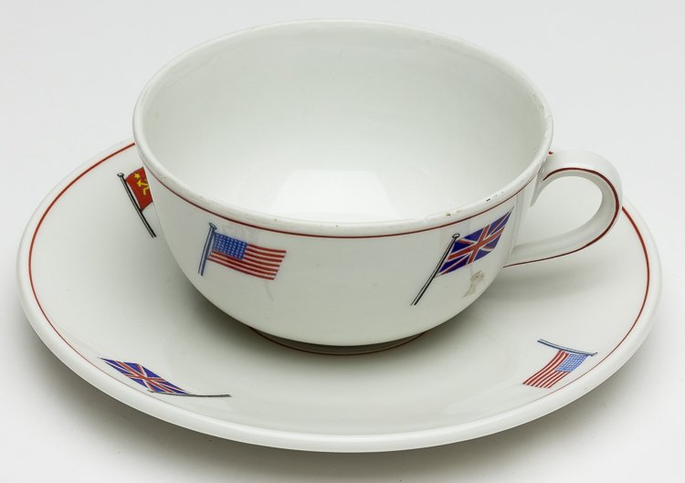 "BIG FOUR" CUP AND SAUCER: "BIG FOUR" CUP AND SAUCER Fine china cup, 3 1/2" diameter, with matching saucer, 6" diameter, each decorated around the rim with the flags of Britain, France, the United States, and the Soviet Union. 