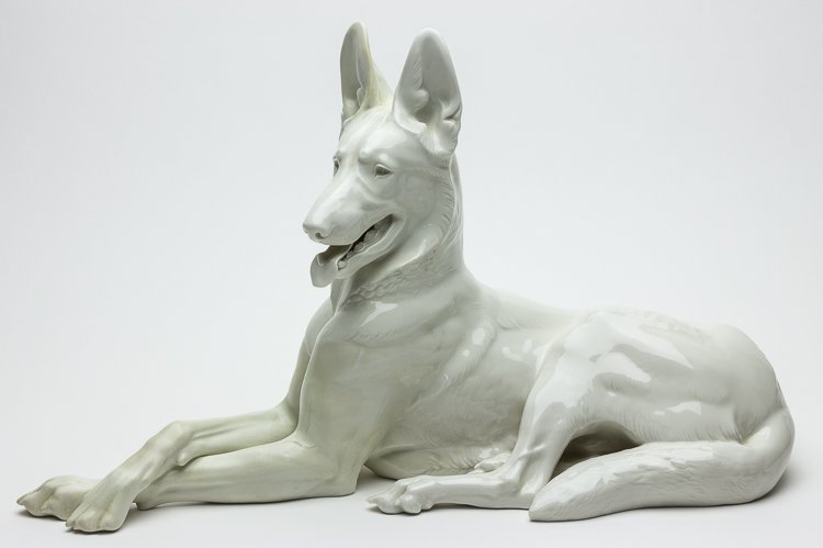 ALLACH RECLINING ALSATIAN (NO. 76): ALLACH RECLINING ALSATIAN (NO. 76) Larger version of the Allach German Shepherd made at the SS factory at Allach based on a design by Prof. Theodor Karner. The piece measures about 17" long and is mar