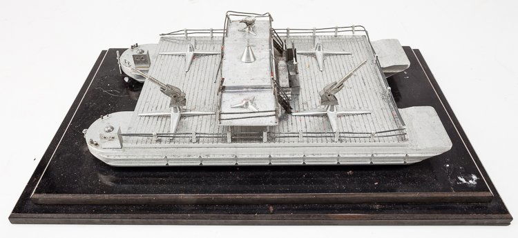 GERMAN ANTI-AIRCRAFT BARGE DESK MODEL: GERMAN ANTI-AIRCRAFT BARGE DESK MODEL Unusual aluminum desk model of a German anti-aircraft barge, 12 1/2" x 8" overall, a hand-made model large anti-aircraft artillery and smaller machine guns, a nav
