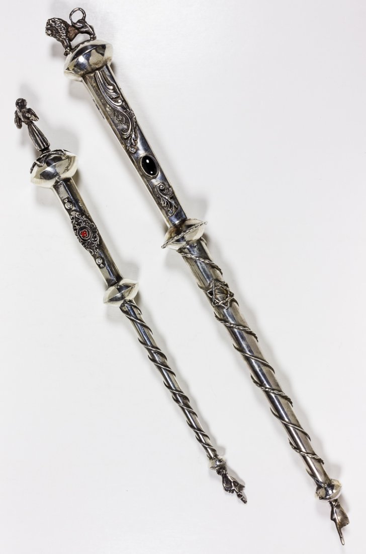 RUSSIAN TORAH POINTERS: RUSSIAN TORAH POINTERS Lot of two items, a pair of Russian Torah pointers, one 10 " long, bearing a rabbinical figure at the top, surrounded by a Star of David. The handle bears a red cabochon stone, 