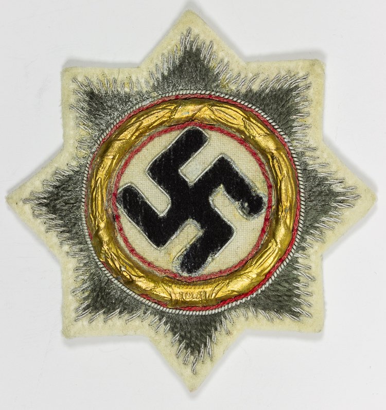 GERMAN CROSS IN GOLD: GERMAN CROSS IN GOLD Cloth form of the German Cross in Gold, 2 3/4" square, consisting of a black mobile swastika, outlined in silver thread, surround be a gold metallic wreath dated "1941" and border