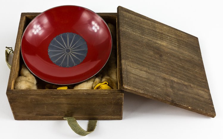 IMPERIAL JAPANESE SAKE CUP: IMPERIAL JAPANESE SAKE CUP Imperial Japanese sake cup presented by Emperor Hirohito to one of his subjects, most likely a military man. The small red lacquerware bowl measures 4 1/4" across and 1 3/8"