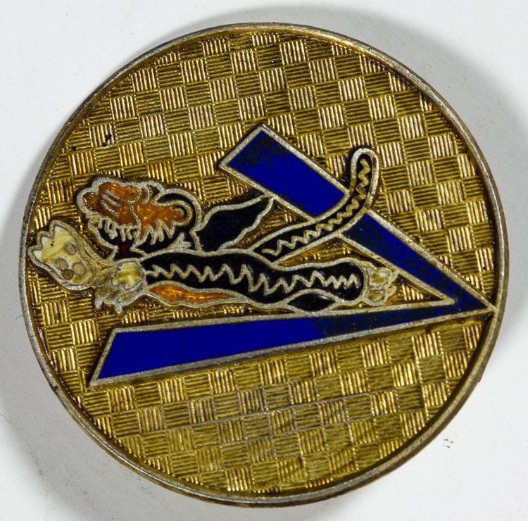 THEATER-MADE FLYING TIGERS HAT BADGE: THEATER-MADE FLYING TIGERS HAT BADGE Circular brass hat badge, 1 1/4" in diameter, featuring the insignia of the 23rd Fighter Group, better known as the Flying Tigers. The insignia consists of a winge