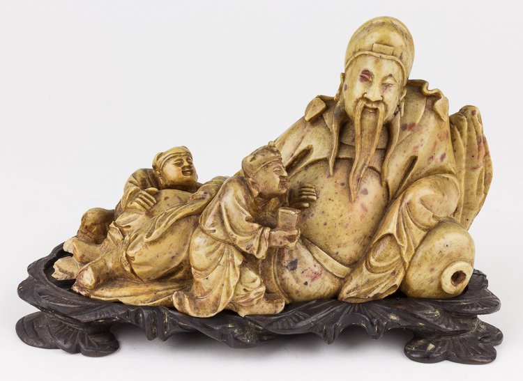 SOAPSTONE CARVING OF SEATED MAN WITH ATTENDANTS: SOAPSTONE CARVING OF SEATED MAN WITH ATTENDANTS Chinese carved stone figure, approx. 7" x 3" x 5", a depiction of the drunken poet Li Dai Bao reclining against his empty wine jug with his bare stomach