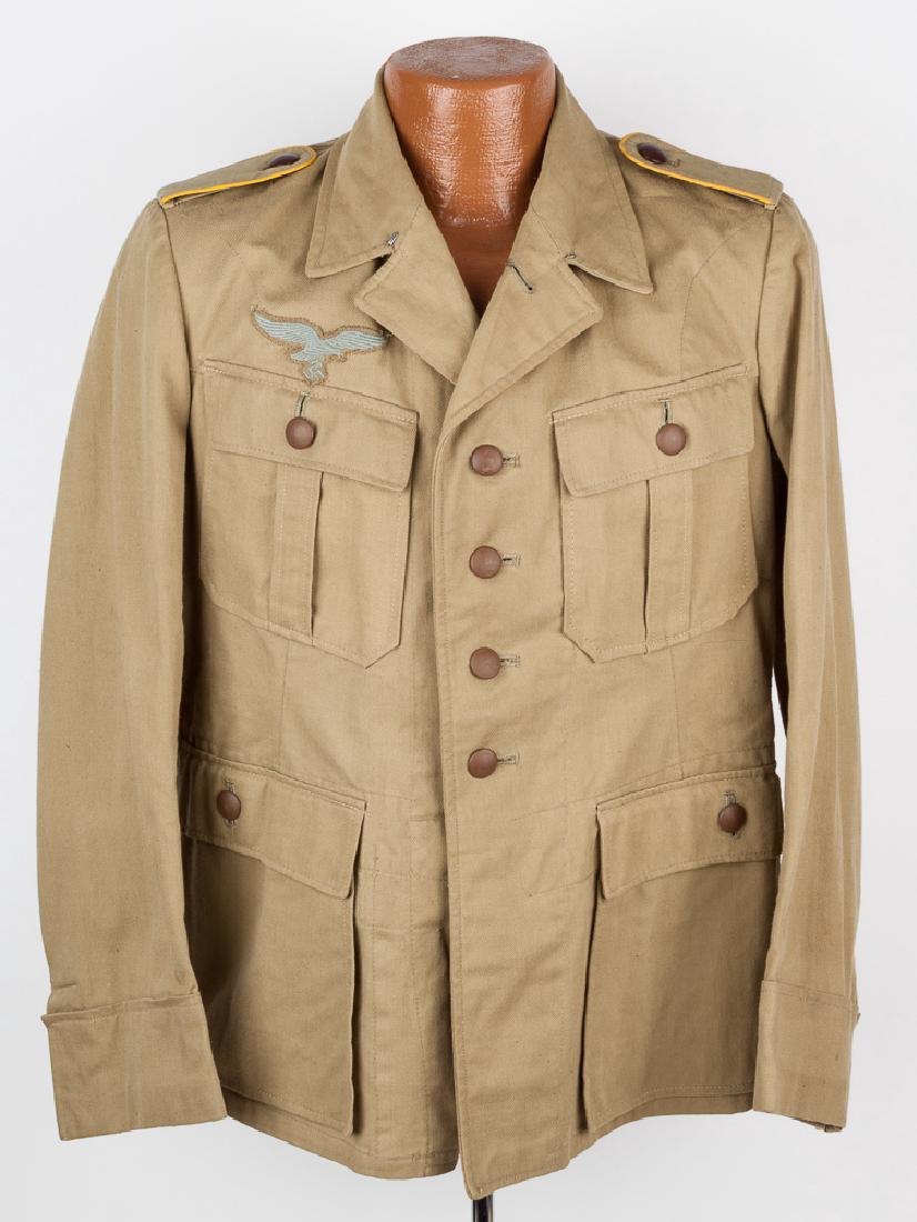 LUFTWAFFE TROPICAL TUNIC: LUFTWAFFE TROPICAL TUNIC Luftwaffe tropical tunic in as-new condition, clearly unissued. The sand-colored twill jacket has four straight-flap pockets on the front which are secured with dark brown hol