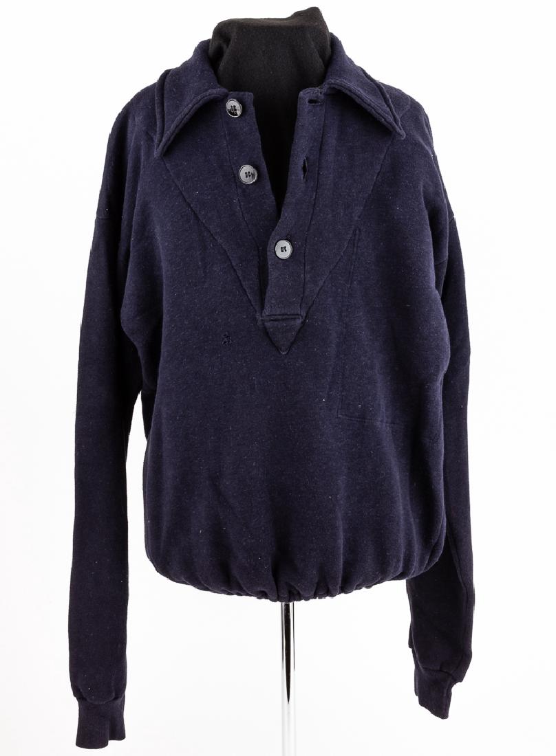 SWEATER WITH HITLER YOUTH SHOULDER PATCH: SWEATER WITH HITLER YOUTH SHOULDER PATCH Navy blue sweater, with a neck opening secured by three black composite buttons. A pocket is sewn into the inside of the left breast. The left sleeve bears a H
