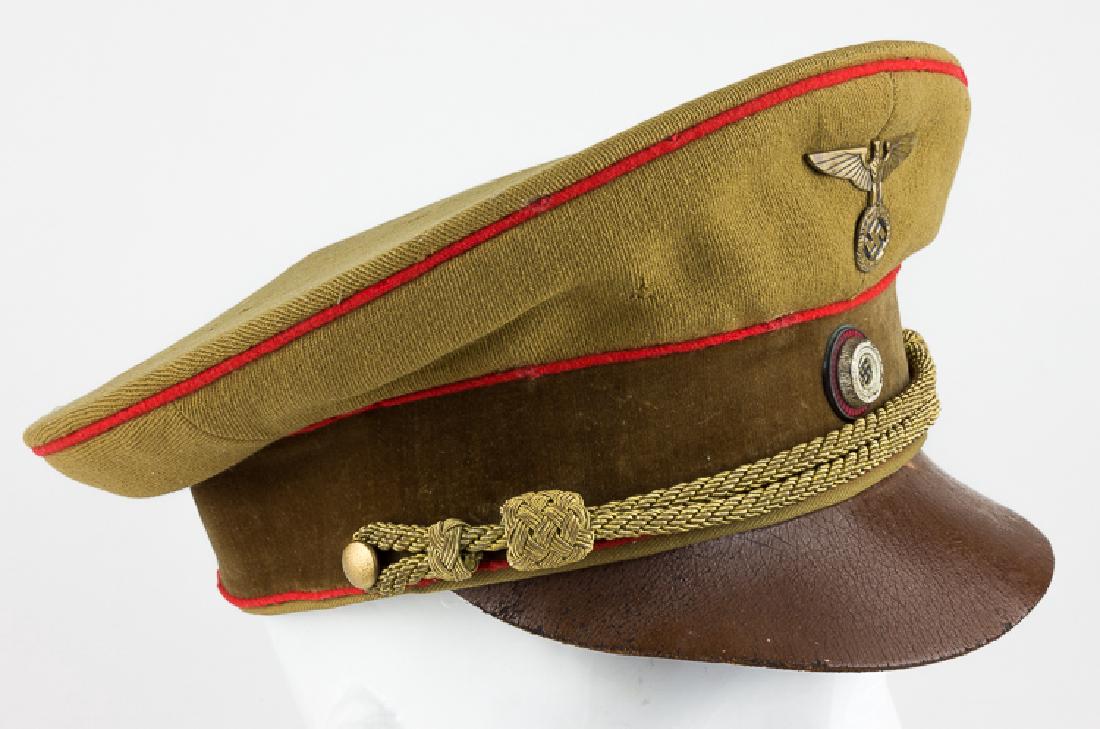 EARLY GAULEITUNG-LEVEL PARTY LEADER'S VISOR CAP: EARLY GAULEITUNG-LEVEL PARTY LEADER'S VISOR CAP Very early NSDAP Gau level political leader's visor hat. The hat is piped in crimson red with a light brown wool top with several moth holes at rear, an