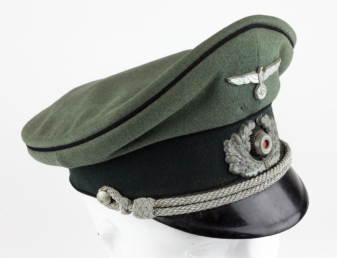 ARMY PIONIER OFFICER'S VISOR CAP: ARMY PIONIER OFFICER'S VISOR CAP Army Pionier officer's visor hat by Erel. This hat features the black crown and cap band piping denoting issuance to a Pionier. The hat's aluminum officer's chin cords