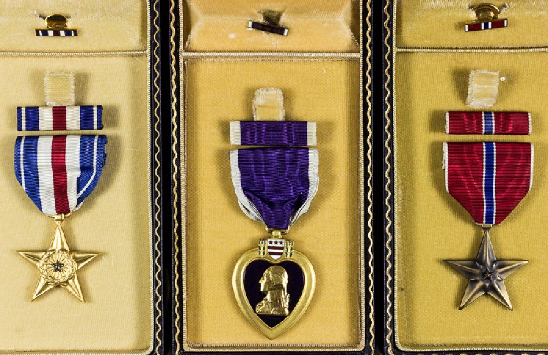 AMERICAN WORLD WAR II MEDALS: AMERICAN WORLD WAR II MEDALS Good lot of three cased World War II-era American military decorations, includes: Cased Purple Heart, 3 1/4" x 1 1/2" dia., unnamed and without a maker's mark, along with
