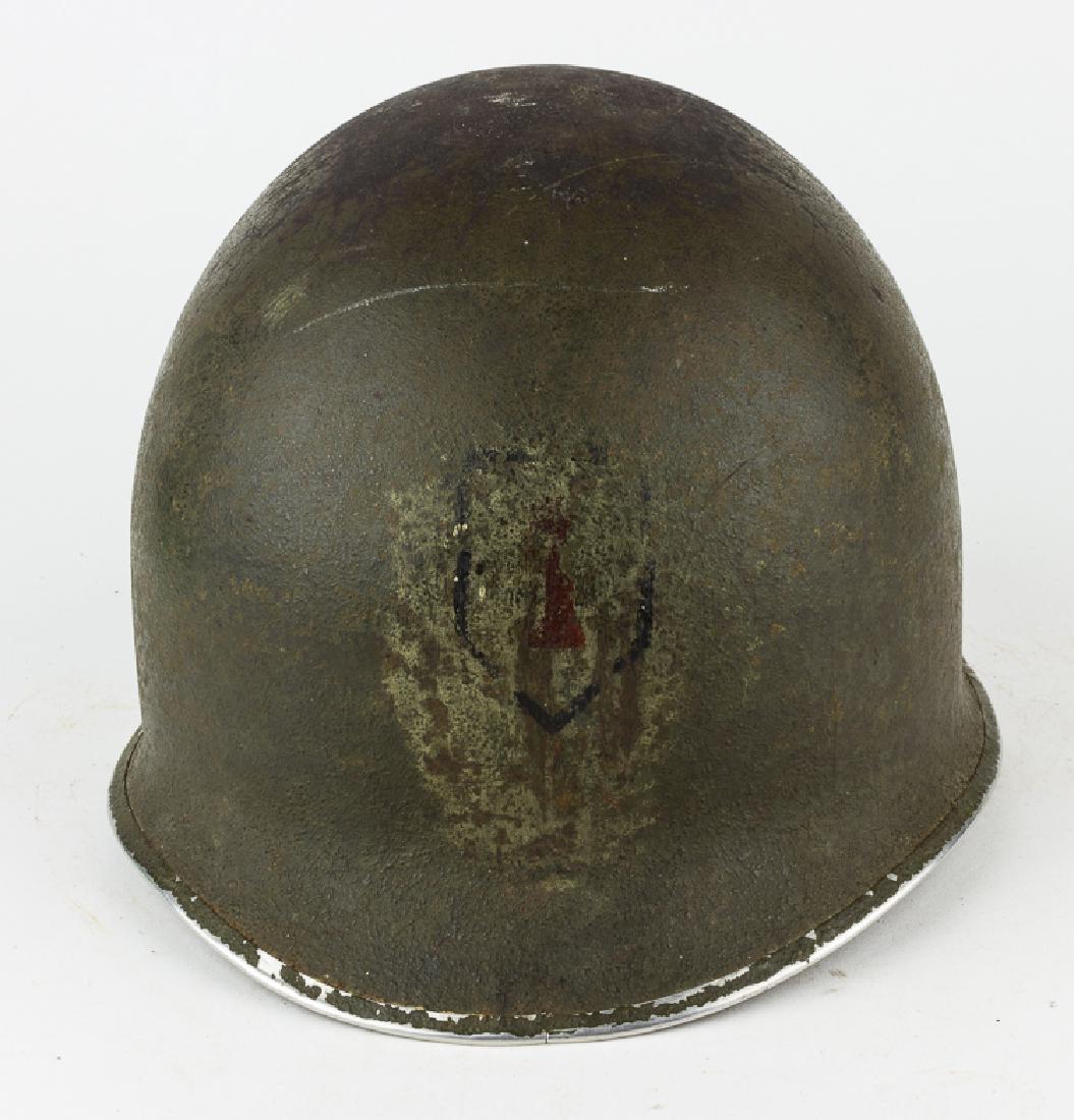M1 HELMET WITH 1ST INFANTRY DIVISION INSIGNIA: M1 HELMET WITH 1ST INFANTRY DIVISION INSIGNIA United States Army M1 steel helmet shell and liner. The shell features fixed strap bales and a seam at the front, with sewn-in straps, and with the paint 