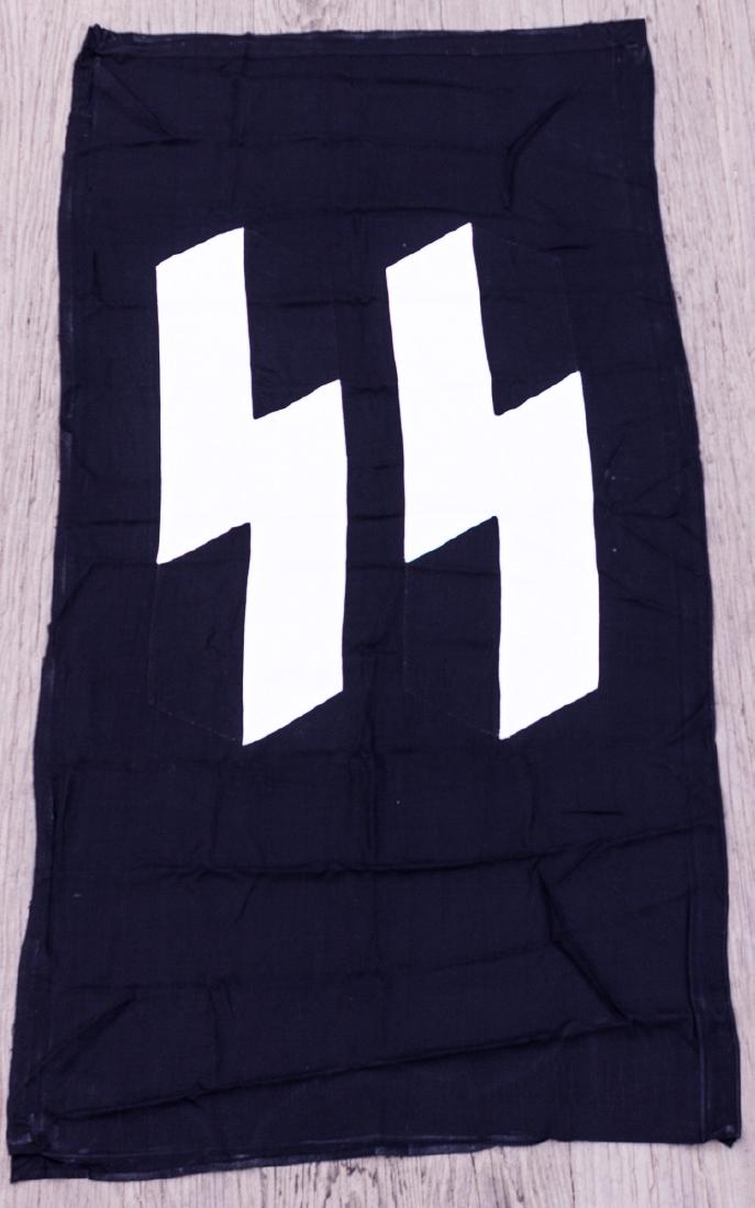 SS BARRACKS FLAG: SS BARRACKS FLAG An exceptional SS barracks flag, 58" x 30", with sewn white SS rune symbols on both sides of the high-quality black cotton banner. The top of the banner has a 1 3/4" wide pole pocket