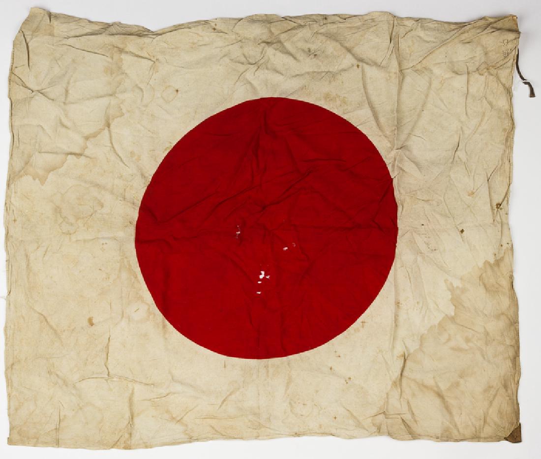 JAPANESE NATIONAL FLAG: JAPANESE NATIONAL FLAG Japanes national flag, 32" x 25", well-worn, sopiled, with several holes and very likely recovered in the field by an American soldier. The flag has two reinforced tabs at the e
