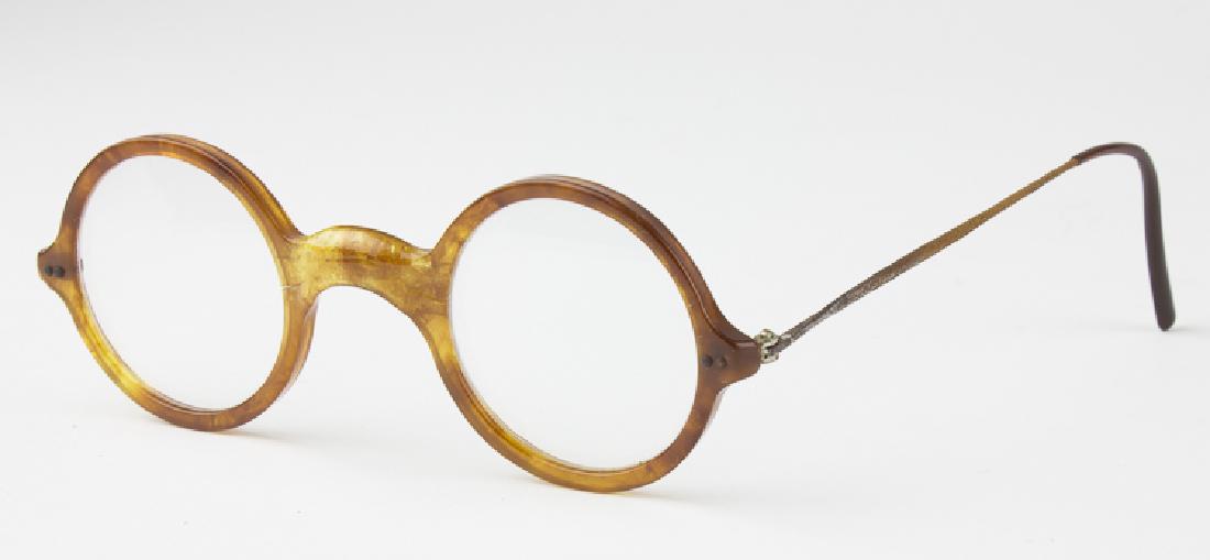 HERMANN GORING'S EYEGLASSES AND CASED MONOCLE: HERMANN GORING'S EYEGLASSES AND CASED MONOCLE A superb pair of personal relics once owned and used by Hermann Goring, horn-rimmed eyeglasses and leather cased monocle. The simple round glasses bear mi