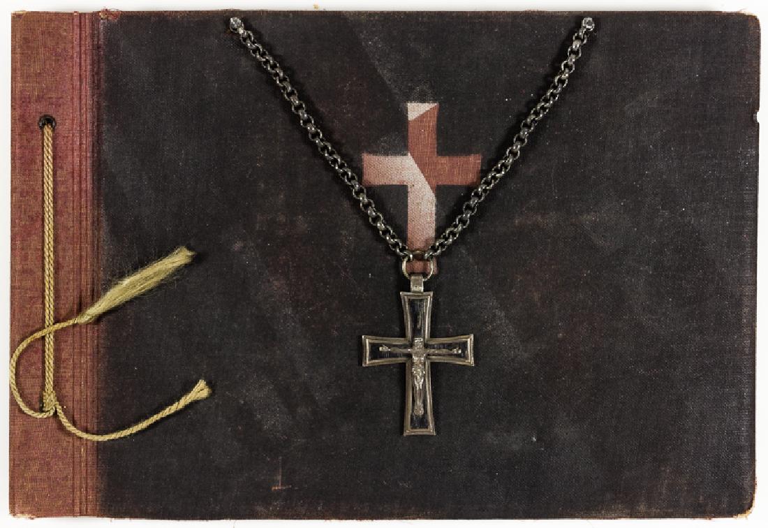 WEHRMACHT CATHOLIC CHAPLAIN'S CROSS AND PHOTO ALBUM: WEHRMACHT CATHOLIC CHAPLAIN'S CROSS AND PHOTO ALBUM German photo album and military chaplain's cross of Roman Catholic Chaplain Anfons Sieber. The 12" x 8 1/4" cloth-covered album bears a black-painte