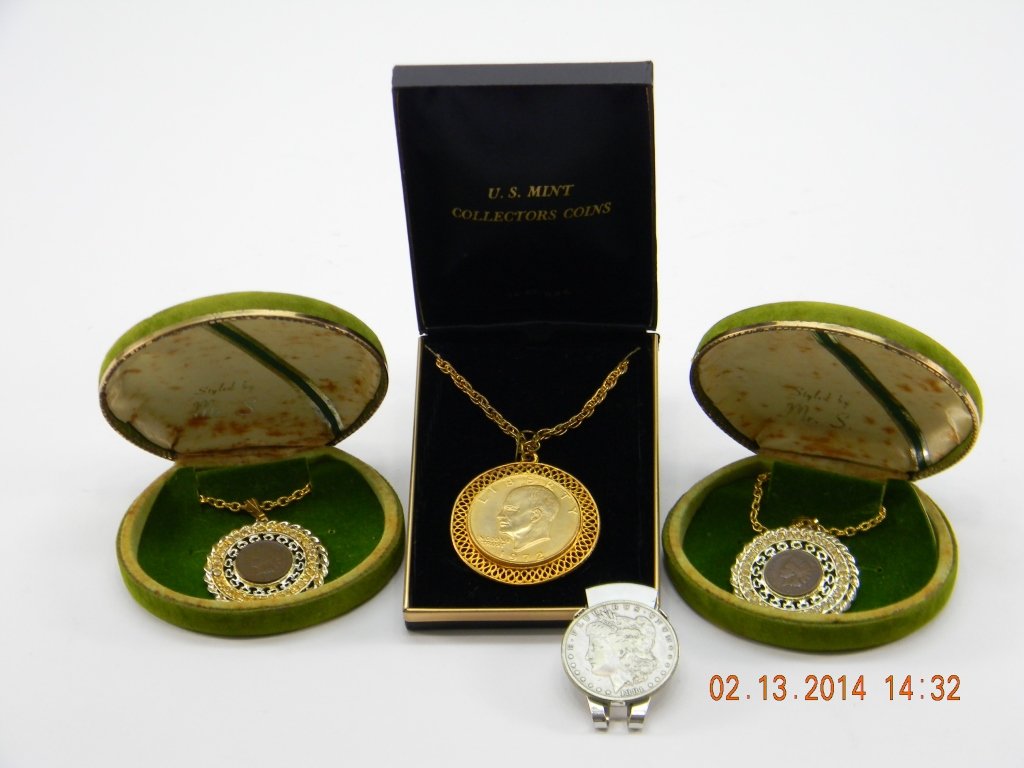 Lot of Indian Head, Morgan Dollar Jewelry: Lot includes 1903 Indian head penny pendant. A 1906 Indian head penny pendant. 1972 Eisenhower dollar pendant. A 1881 Morgan Silver Dollar money clip.