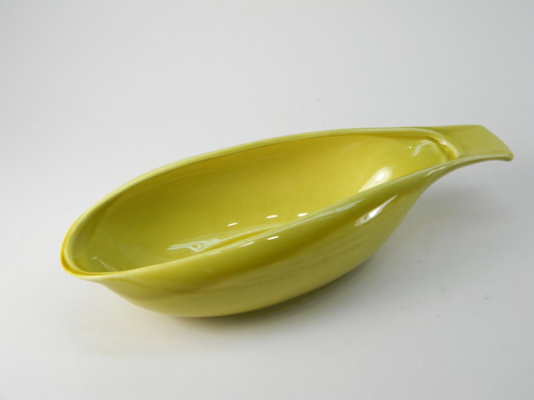 Russel Wright Ceramic Yellow Handled Gravy Bowl: Ceramic Yellow Handled Gravy Bowl. Size: 10'' long by 3'' wide. Unsigned.