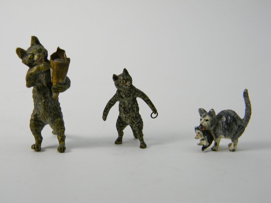 3 Austrian Cold Painted Bronze Cat Figures: Two antique Austrian Cold Painted Bronze cat animalier figurines. Tallest is 2.25''. Medium cat is 1.75'' tall. One sitting cat with kitten in mouth is1'' tall and is not Austrian. There is some wear 