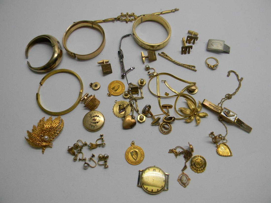 Lot of Gold Filled Jewelry: Large lot of gold filled jewelry includes locket, ladies watch, bracelets, pins, charms, tie pin, cuff links, Wittnauer watch, and earrings total weight is 274 g. All pieces are marked gold filled.