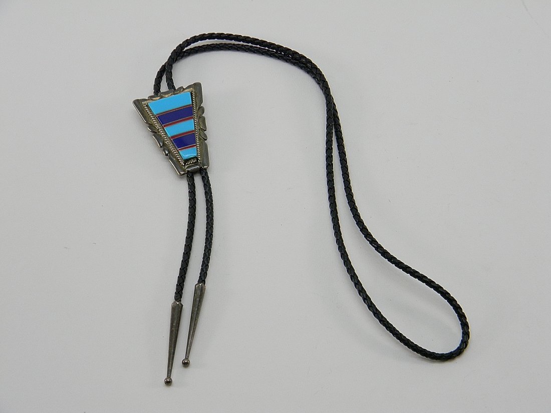 Sterling Silver & Leather Bolo Tie: Sterling silver and leather Bolo tie with turquoise, red, and blue colored design on the front. Tips are sterling silver. Length 18''. Weight of sterling 24.5 grams