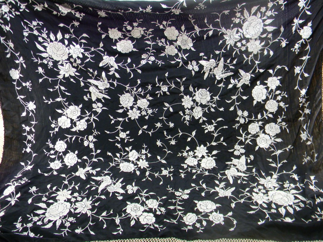 Antique Black & White Silk Piano Shawl: Black silk with white silk embroidery. Embroidered by hand, long hand knotted fringe. Dimensions are 49” x 50”, this does not include length of fringe which is 18” long. Including fringes 67” 