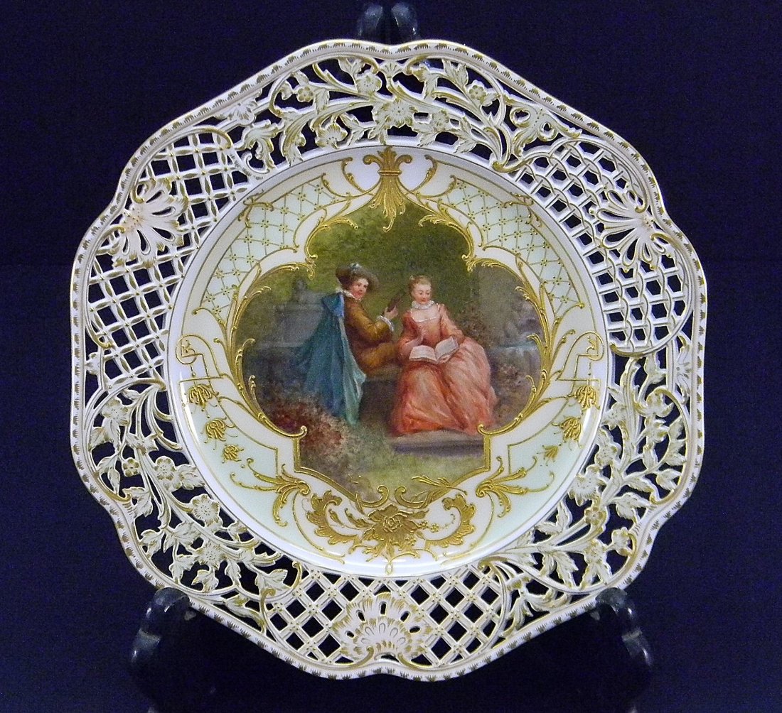 Fine Berlin KPM Hand Painted Porcelain Plate: Fine reticulated gold gilt and hand painted 18th century scene of a man and woman seated on bench surrounded by statuary in garden framed in gold gilt decorations. Berlin KPM mark.. Very good conditio
