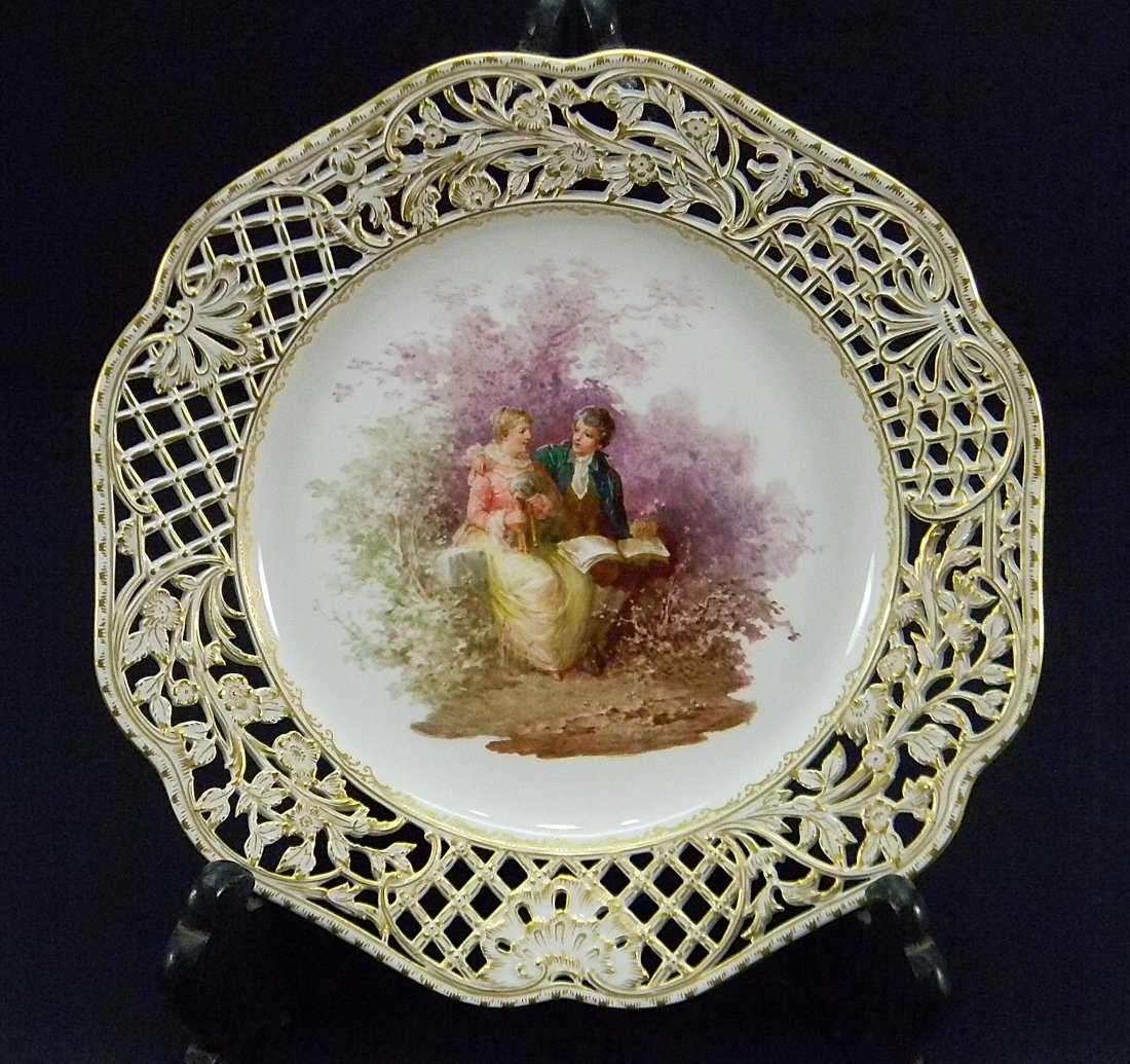 Berlin KPM Hand Painted Porcelain Plate Garden: Fine reticulated gold gilt and hand painted scene of a man and woman seated on bench in garden. Berlin KPM mark.. Very good condition. Approx 9'' in diameter.