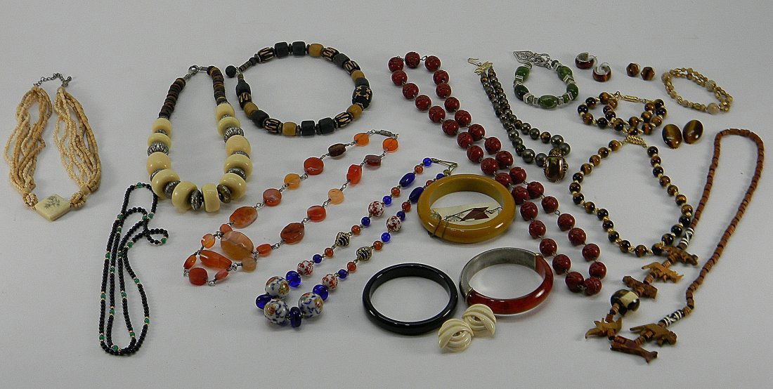 Lot of Asian African Style Jewelry Kirk, AK: Lot includes:1 porcelain enamel blue beaded necklace, 1 orange strawberry oval quartz beaded necklace, 4 Asian African style beaded necklaces, 1 Alexis Kirk tan bangle, 1 black & 1 silver & tortoise s