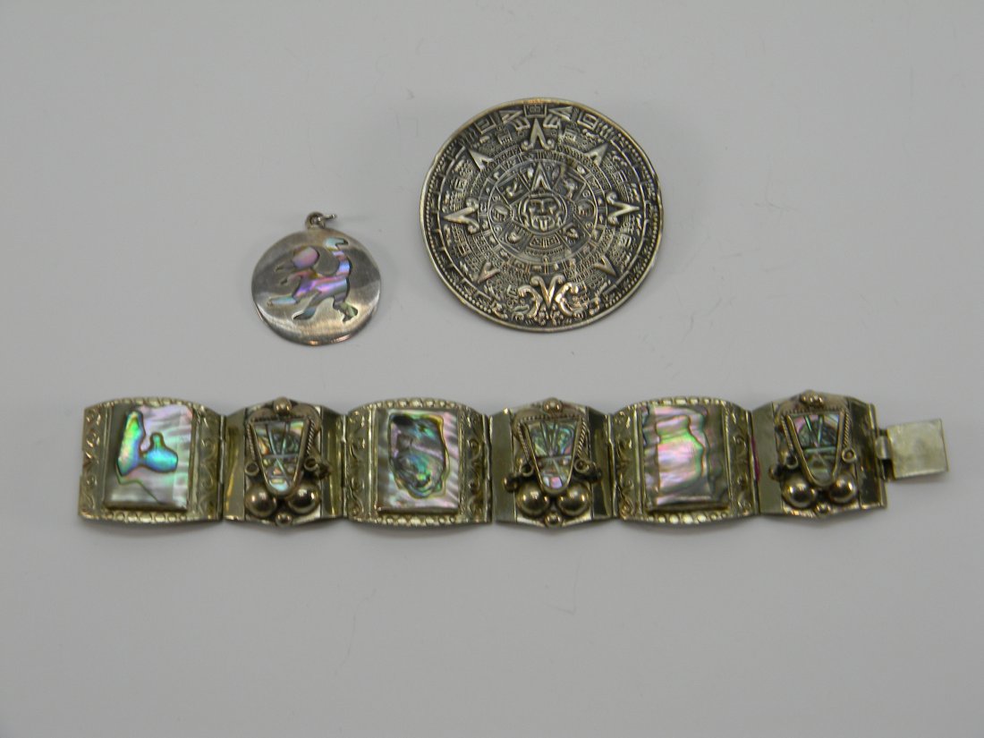 Lot Sterling Taxco Los Ballesteros Bertha Bracelet, Pin: Lot includes: 1 Abalone Bracelet marked "Eagle" 925 Mexico, 1 Aztec Calendar brooch or pendant marked "Bertha" 925, 1 abalone dancing figure of an Aztec round pendant marked w/ "Los Ballesteros Taxco
