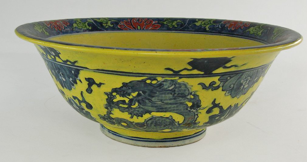 Chinese Blue and White Bowl with Yellow Enameling: Blue and white Chinese bowl with Dragon and floral design, underglaze blue with overglaze yellow enamel. Bowl has crack,wear to yellow enamel on bowl interior. Height: 3 3/8 Inches (8.7 cm)Width : 9 I