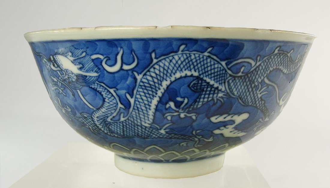 Chinese Underglaze Blue Kangxi Dragon Bowl Reign Mark: Well painted Chinese Kanghsi bowl with underglaze blue dragon decoration and Kangxi six character mark. There are several chips to the rim of the bowl, some with age, and one with a small hairline. He
