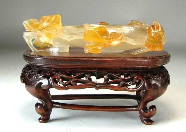 Chinese Carved Agate Brushwasher Carnelian Russet Stand: Well carved Chinese agate brush washer with carved russet leaves along vine. The coupe sits on a rosewood type stand. Height on Stand: 2 7/8 Inches (7.5 cm) Height Brushwasher: 1 Inches (2.5 cm) Lengt