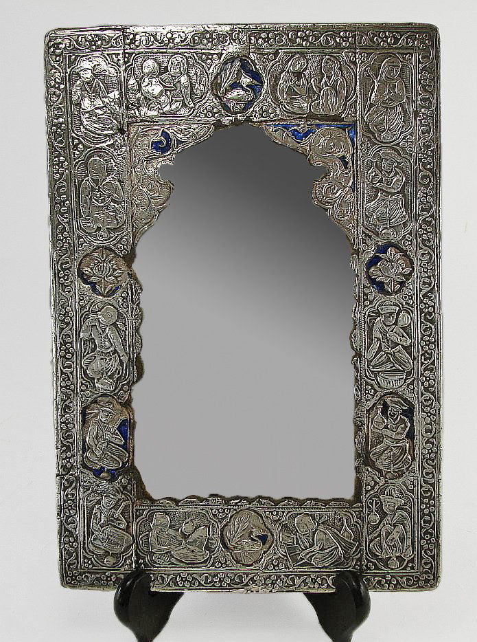 Silvered and Enameled Persian Courting Mirror: Persian silvered and enameled Persian courting mirror featuring floral designs on the back, and small scenes on the front. There are some losses to the enamel and silver.
