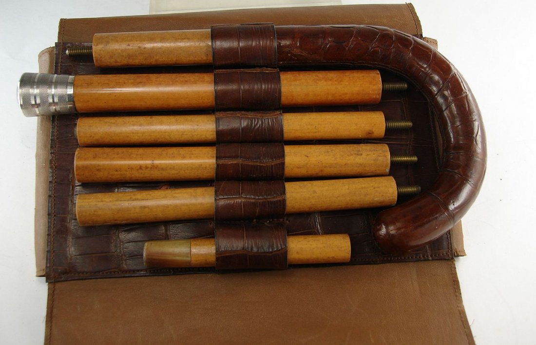 Sterling Collapsible Travel Cane With Reptile Skin Case: Collapsible travel cane with two handles, one with a reptile skin covering and one with a silver head engraved FG, 5 part cane in total with two heads. The cane also comes with reptile skin carrying c