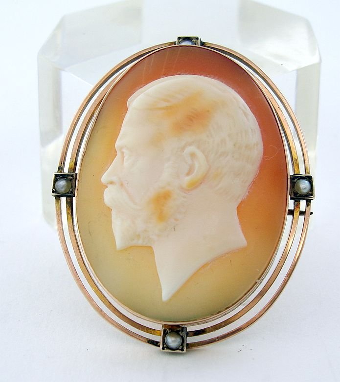 9 kt Gold Cameo King George V w Pearls: Well carved cameo of what appears to be King George V in a marked 9 ct gold setting inset with pearls.Height:1 3/4 Inches (4.2 cm)Width :1 3/8 Inches (3.5 cm)